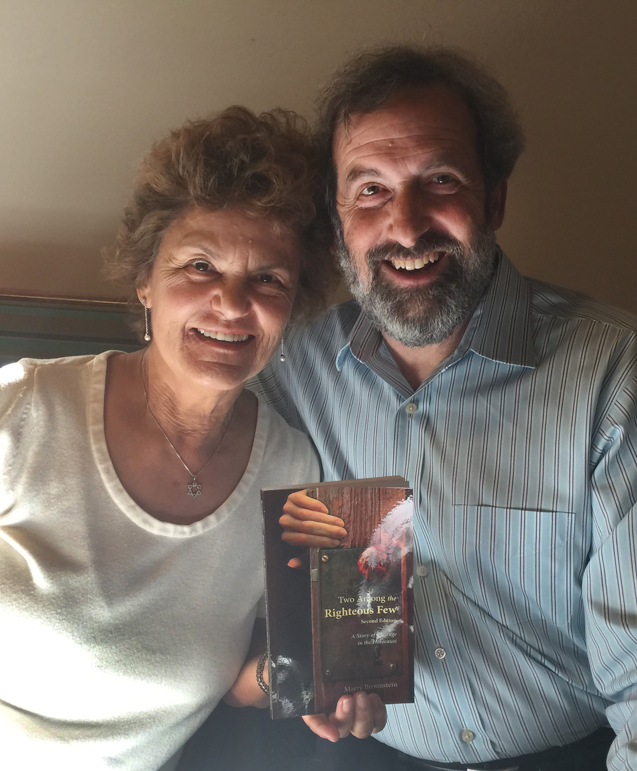Marty Brounstein, author of “Two Among the Righteous Few: A Story of Courage in the Holocaust,” poses in early April with his wife, Leah Baars.